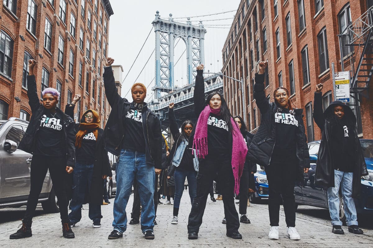 Group of teenagers raising their fists in protest in new york